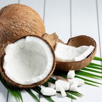 fresh coconuts put on white wooden background